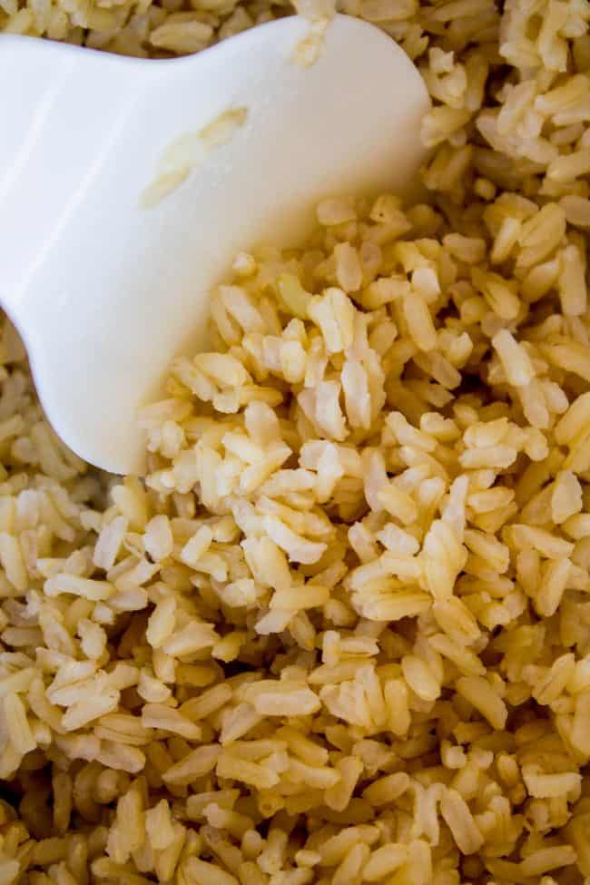 fluffy brown rice with a rice paddle.