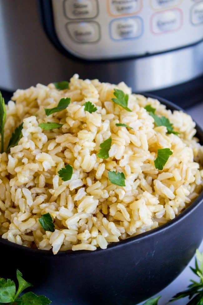 brown rice topped with cilantro in a bowl next to the Instant Pot.