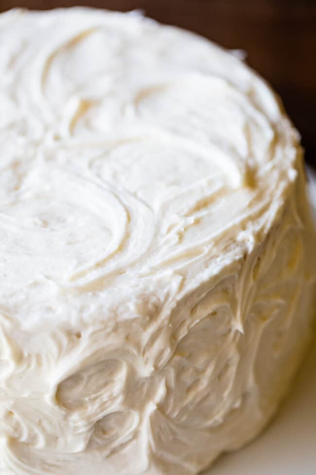 The Best Homemade White Cake Recipe of Your Life from The Food Charlatan. HALLELUJAH! Finally a moist white cake from scratch that doesn't taste like cardboard. I promise, this will be the best homemade white cake recipe of your life! It's soft and fluffy, while still being super moist. The balance of fluffy and moist is exactly perfect for how cake ought to be! It's fluffy yet full of buttery rich flavor. #white #cake #homemade #recipe #moist #fromscratch #easy #frosting #best #simple #perfect gorgeous layer cake with swirled vanilla frosting.