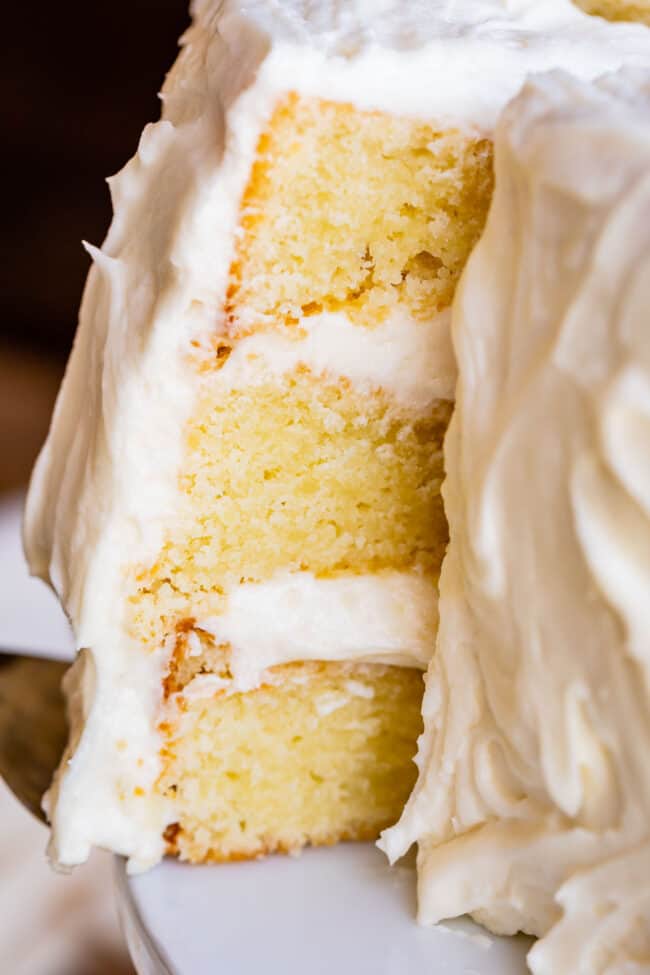 The Best Homemade White Cake Recipe of Your Life from The Food Charlatan. HALLELUJAH! Finally a moist white cake from scratch that doesn't taste like cardboard. I promise, this will be the best homemade white cake recipe of your life! It's soft and fluffy, while still being super moist. The balance of fluffy and moist is exactly perfect for how cake ought to be! It's fluffy yet full of buttery rich flavor. #white #cake #homemade #recipe #moist #fromscratch #easy #frosting #best #simple #perfect homemade white cake with vanilla frosting.