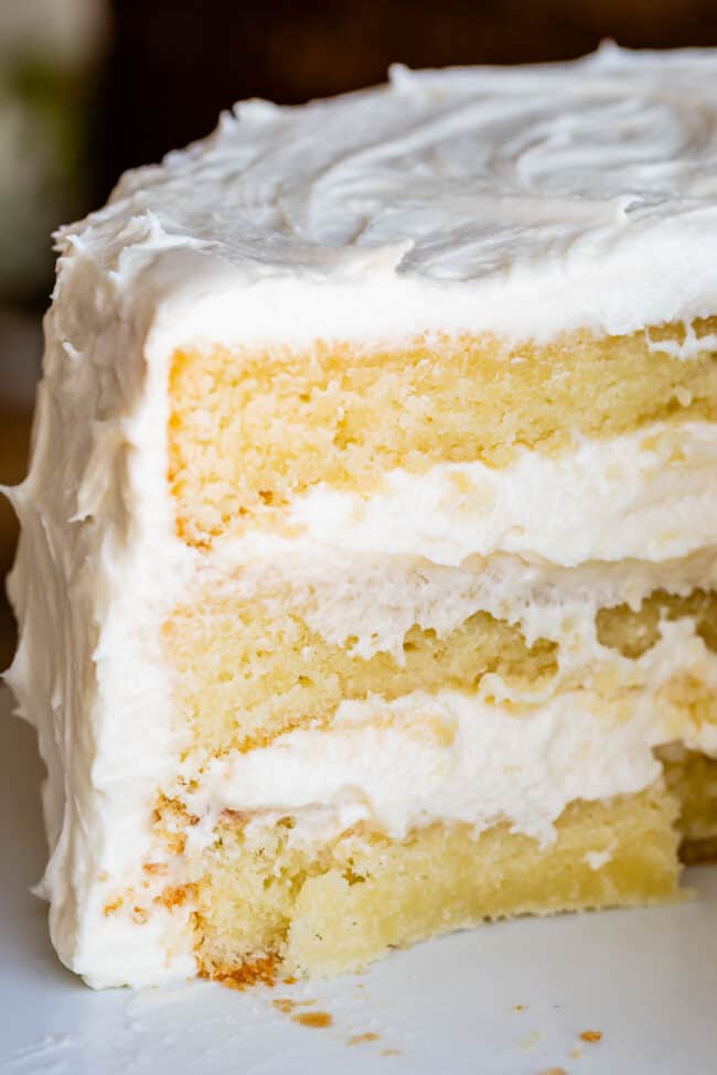 The Best Homemade White Cake Recipe of Your Life from The Food Charlatan. HALLELUJAH! Finally a moist white cake from scratch that doesn't taste like cardboard. I promise, this will be the best homemade white cake recipe of your life! It's soft and fluffy, while still being super moist. The balance of fluffy and moist is exactly perfect for how cake ought to be! It's fluffy yet full of buttery rich flavor. #white #cake #homemade #recipe #moist #fromscratch #easy #frosting #best #simple #perfect white cake with vanilla frosting.