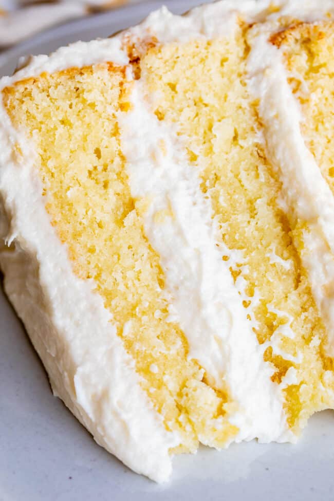 The Best Homemade White Cake Recipe of Your Life from The Food Charlatan. HALLELUJAH! Finally a moist white cake from scratch that doesn't taste like cardboard. I promise, this will be the best homemade white cake recipe of your life! It's soft and fluffy, while still being super moist. The balance of fluffy and moist is exactly perfect for how cake ought to be! It's fluffy yet full of buttery rich flavor. #white #cake #homemade #recipe #moist #fromscratch #easy #frosting #best #simple #perfect white cake with vanilla frosting.