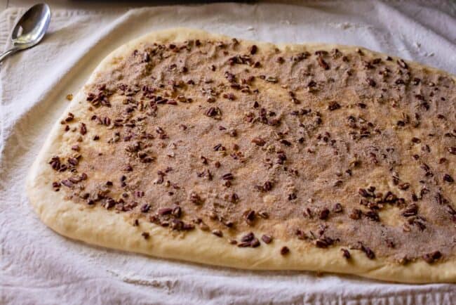 Brioche dough spread with caramel sauce and pecans.