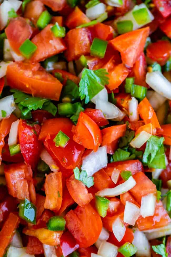 How to Make Authentic Pico de Gallo from The Food Charlatan. Learn how to make the best Pico de Gallo! It's a very simple Mexican salsa with tomatoes, onions, jalapeno, cilantro, and lime juice. Humble ingredients come together to make one of the best appetizers of all time! You will never look at tacos the same after topping them with this magical stuff. #picodegallo #salsa #Mexican #cold #fresh #appetizer #dip #forparties #easy #recipe #receta #authentic #best #homemade #restaurant #picodegalo homemade pico de gallo.