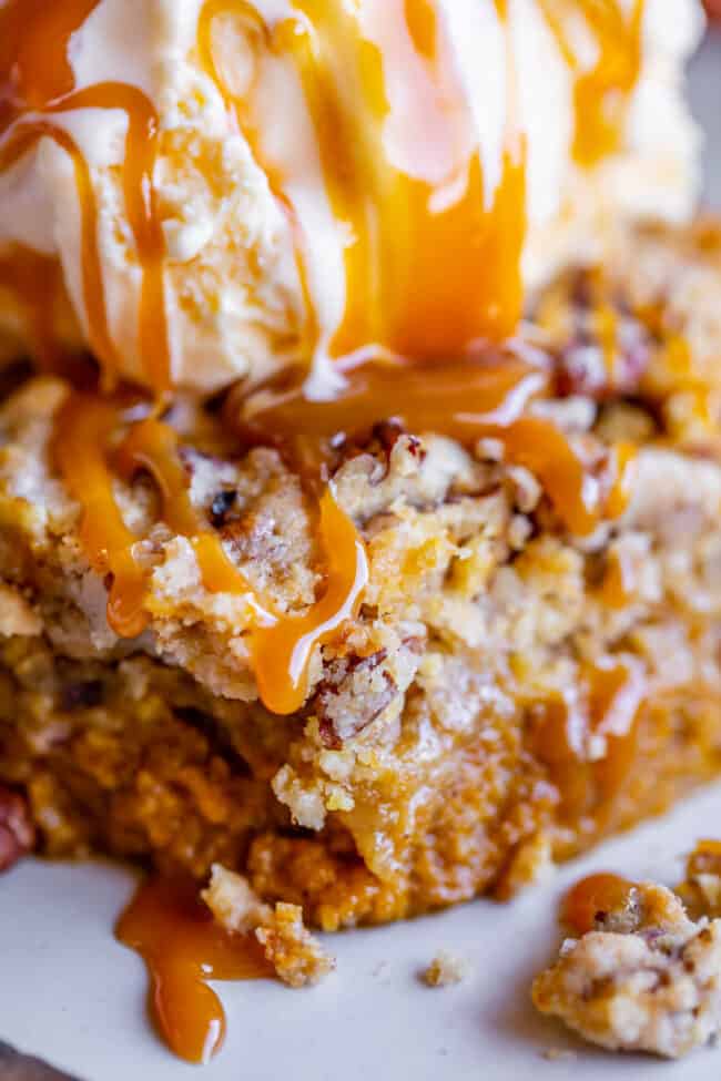 slice of pumpkin pie dump cake drizzled with caramel.