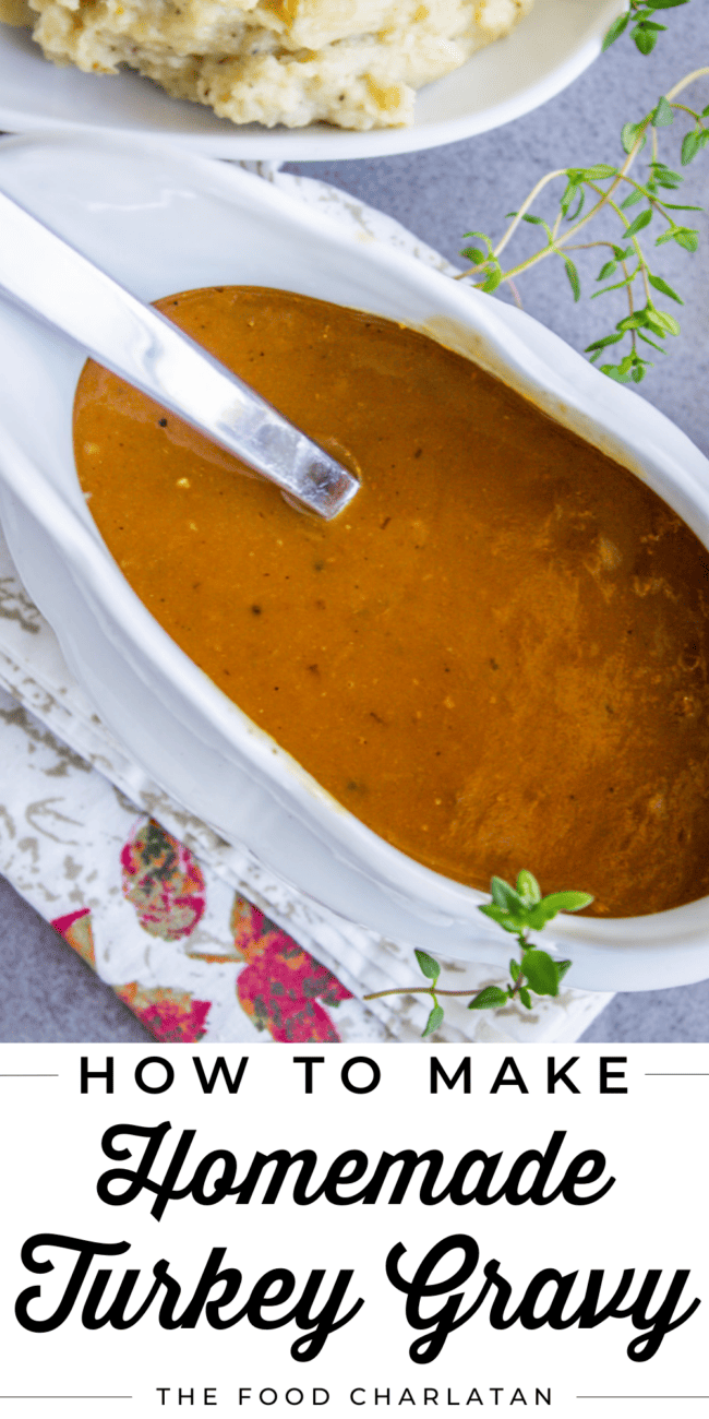 homemade turkey gravy in a white gravy boat with a ladle in it.