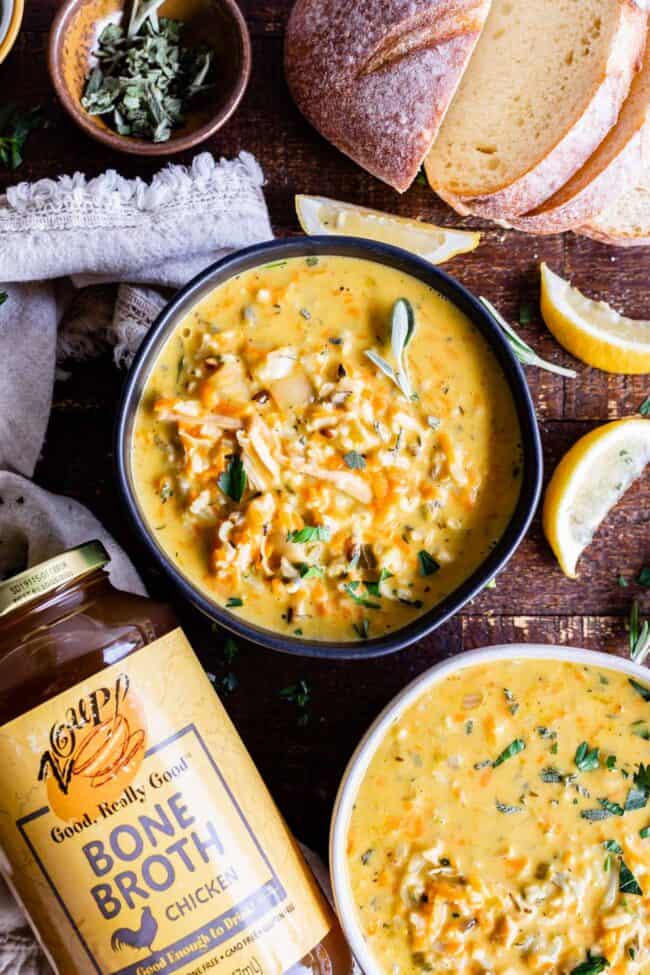 Creamy Turkey Wild Rice Soup recipe from The Food Charlatan! Use your leftover turkey and herbs from Thanksgiving to make a satisfying and healthy soup that is just what you need after all the carb loading you did on Thursday. (I know you.) The hint of lemon and the shredded carrots make this soup really unique and flavorful! #turkey #thanksgiving #christmas #broth #stock #carrots #creamy #crockpot #slowcooker #recipes #leftover #easy #healthy #homemade #carrots #lemon #leftovers #stovetop creamy turkey soup in a bowl next to sliced bread and napkin