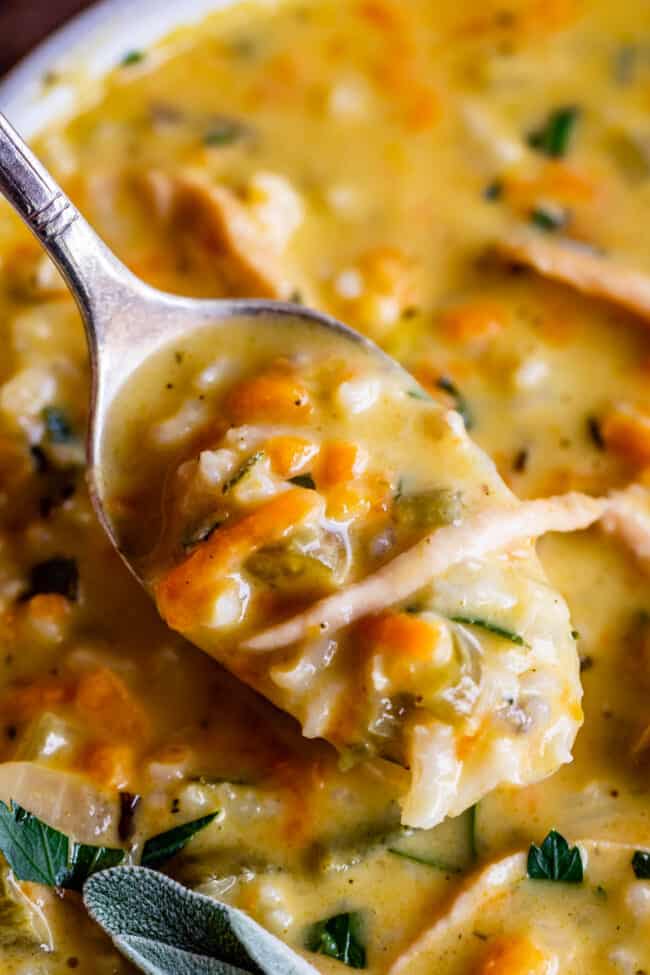 Creamy Turkey Wild Rice Soup recipe from The Food Charlatan! Use your leftover turkey and herbs from Thanksgiving to make a satisfying and healthy soup that is just what you need after all the carb loading you did on Thursday. (I know you.) The hint of lemon and the shredded carrots make this soup really unique and flavorful! #turkey #thanksgiving #christmas #broth #stock #carrots #creamy #crockpot #slowcooker #recipes #leftover #easy #healthy #homemade #carrots #lemon #leftovers #stovetop cream of turkey soup on a soup featuring a bit of turkey meat