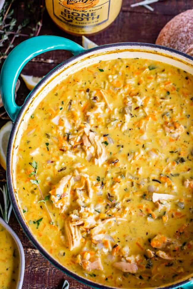 Creamy Turkey Wild Rice Soup recipe from The Food Charlatan! Use your leftover turkey and herbs from Thanksgiving to make a satisfying and healthy soup that is just what you need after all the carb loading you did on Thursday. (I know you.) The hint of lemon and the shredded carrots make this soup really unique and flavorful! #turkey #thanksgiving #christmas #broth #stock #carrots #creamy #crockpot #slowcooker #recipes #leftover #easy #healthy #homemade #carrots #lemon #leftovers #stovetop turkey wild rice soup in a blue crockpot
