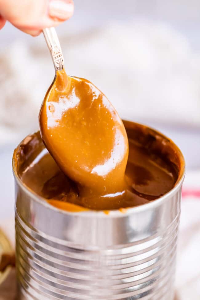 sweetened condensed milk cooked into dulce de leche, with a spoon.