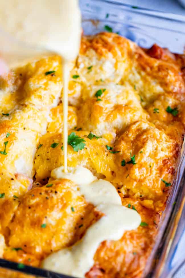 Cheesy Ham and Egg Breakfast Casserole with Biscuits from The Food Charlatan. This crowd-pleasing casserole is my new favorite! Use store bought or homemade biscuits to make a moist and delicious brunch. Top it all off with Hollandaise Sauce for an amazing holiday breakfast! #breakfast #brunch #ham #bacon #sausage #easy #recipe #holidays #Thanksgiving #Christmas #makeahead #withbiscuits #overnight #recipes #foracrowd #best #nightbefore #simple #quick #forlargegroups #Pillsbury #freezer #savory biscuit breakfast casserole with hollandaise.