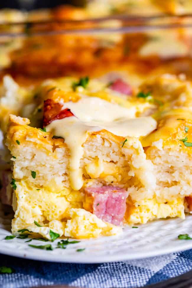 Cheesy Ham and Egg Breakfast Casserole with Biscuits from The Food Charlatan. This crowd-pleasing casserole is my new favorite! Use store bought or homemade biscuits to make a moist and delicious brunch. Top it all off with Hollandaise Sauce for an amazing holiday breakfast! #breakfast #brunch #ham #bacon #sausage #easy #recipe #holidays #Thanksgiving #Christmas #makeahead #withbiscuits #overnight #recipes #foracrowd #best #nightbefore #simple #quick #forlargegroups #Pillsbury #freezer #savory ham and cheese breakfast casserole with biscuits and hollandaise.