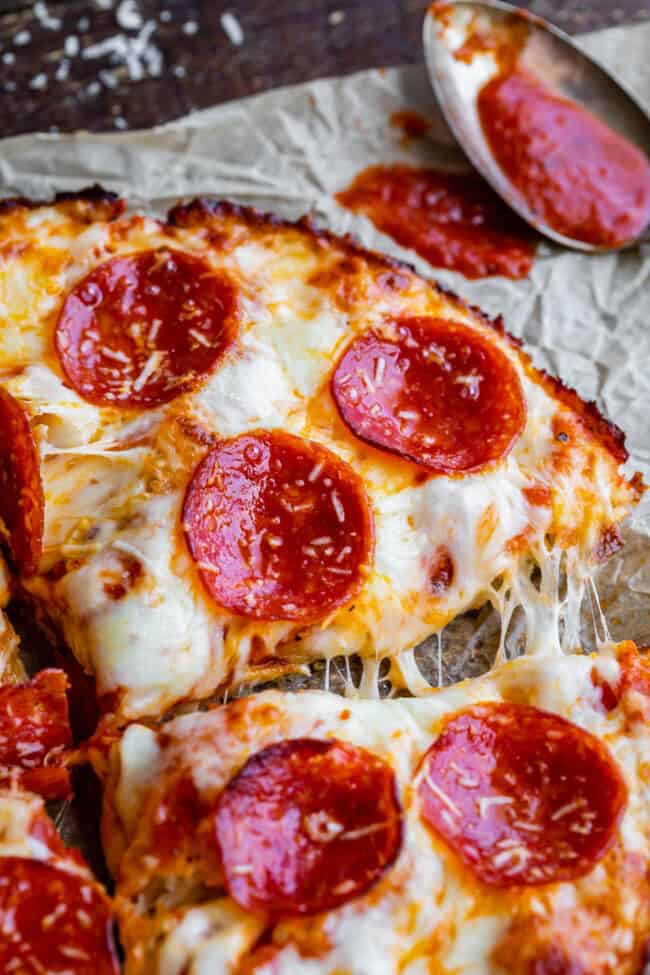 copycat pizza hut pan pizza  cut into slices on parchment paper.