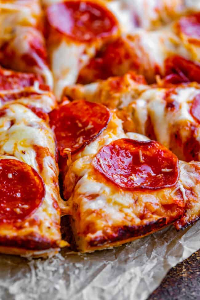 handmade pan pizza cut into slices.