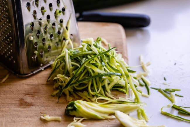 using a box grater to make zucchini "noodles".