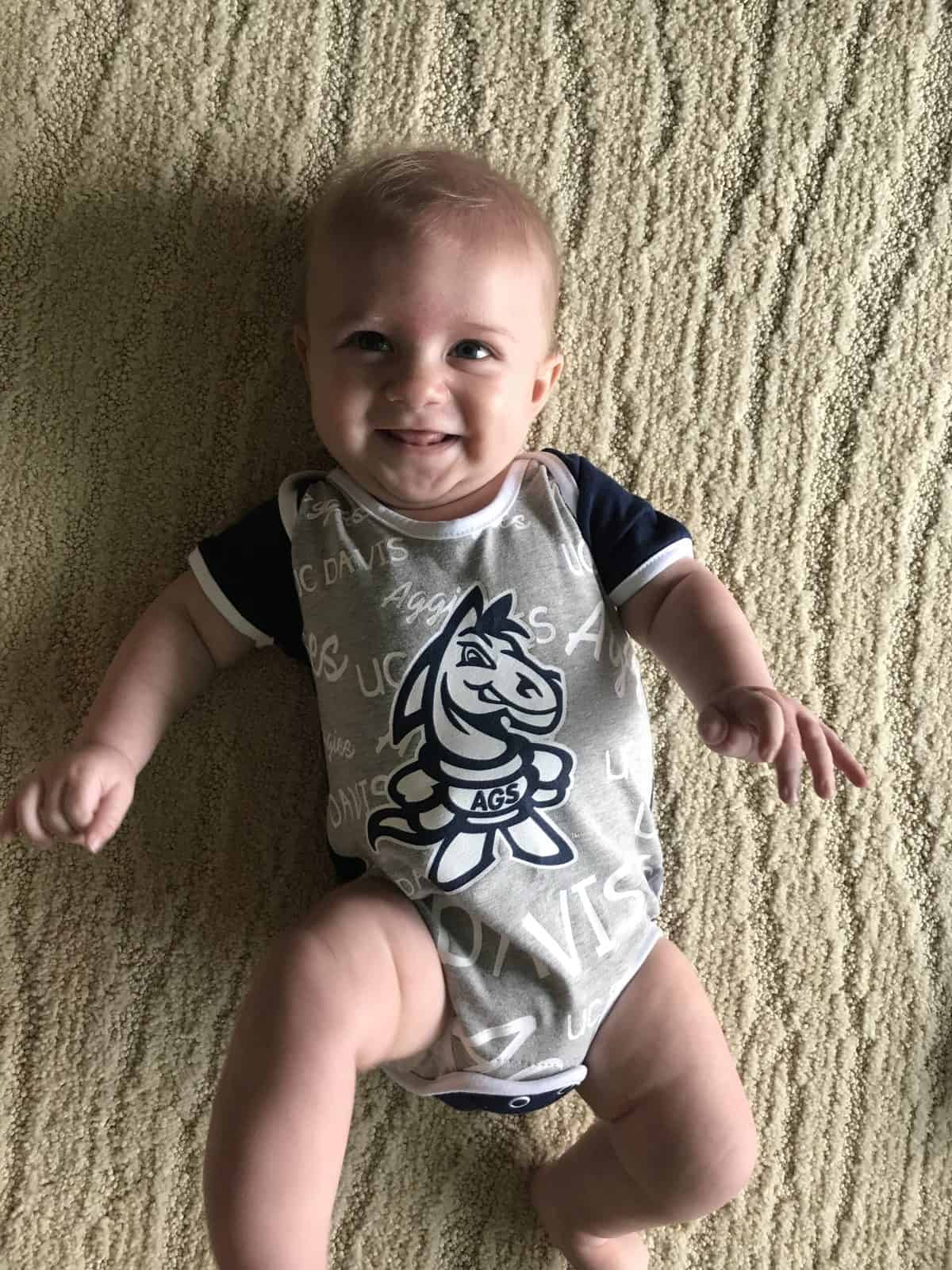 Baby in UCD Aggie onesie