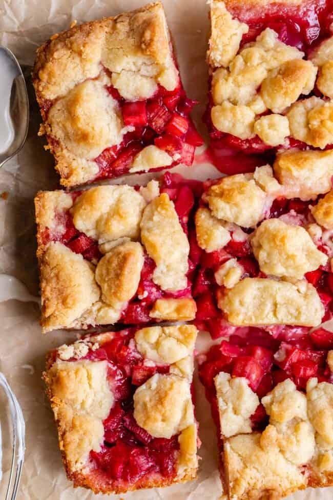 Rhubarb Shortbread Bars from The Food Charlatan. Rhubarb Shortbread Bars are a dream come true! A thick and buttery shortbread crust, topped with a layer of simple rhubarb filling, and topped with even more glorious shortbread. There is a secret ingredient in this recipe that makes these rhubarb bars bright ruby red, and it's not food coloring. It works like a charm! #easy #recipe #rhubarb #shortbread #butter #bars #dessert #withoutstrawberry #recipe #shortbreadcrust #lemon #best #pie rhubarb bars with shortbread crust