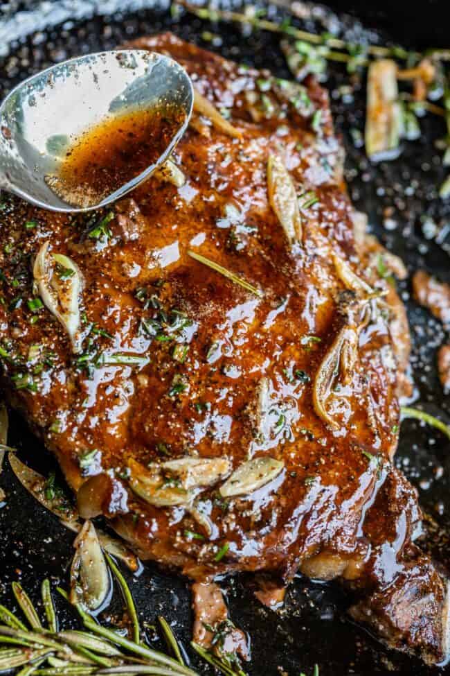 grilled ribeye steak with garlic butter and herbs.