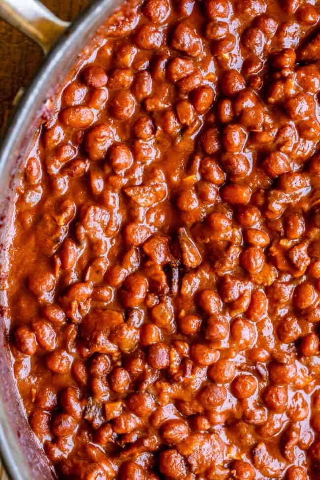 Santa Maria Pinquito Beans from The Food Charlatan. These Santa Maria style Pinquito Beans are the perfect summer barbecue side dish! Originally created in Santa Maria, California to be served alongside Grilled Tri Tip, these beans are smokey and sweet with the perfect blend of spices. Eat them with tri tip or serve alongside whatever else you're barbecuing this summer! #easy #recipe #bbq #barbecue #beans #bakedbeans #santamaria #tritip #sidedish #bacon #pinquito #creamy #summer #onion #anaheim santa maria beans in a pan.