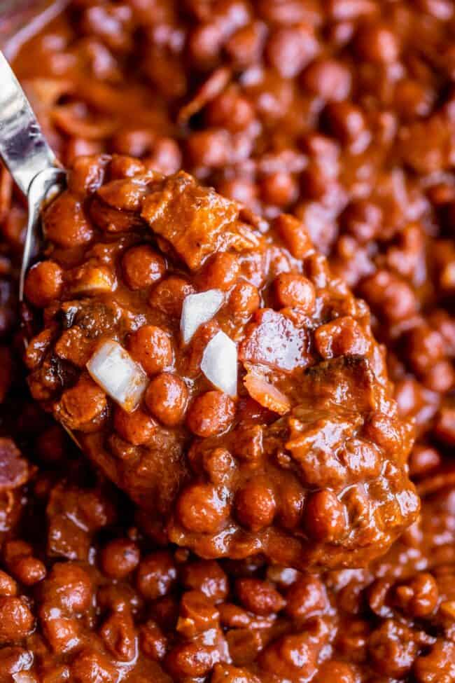 Santa Maria Pinquito Beans from The Food Charlatan. These Santa Maria style Pinquito Beans are the perfect summer barbecue side dish! Originally created in Santa Maria, California to be served alongside Grilled Tri Tip, these beans are smokey and sweet with the perfect blend of spices. Eat them with tri tip or serve alongside whatever else you're barbecuing this summer! #easy #recipe #bbq #barbecue #beans #bakedbeans #santamaria #tritip #sidedish #bacon #pinquito #creamy #summer #onion #anaheim spoonful of santa maria beans.
