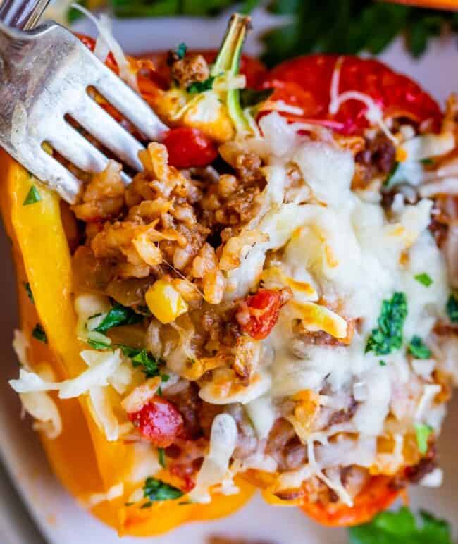 how to make stuffed peppers showing fork in rice stuffed into pepper