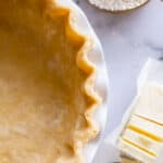 overhead shot of fluted raw pie crust in a pan