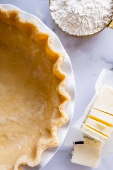 overhead shot of fluted raw pie crust in a pan