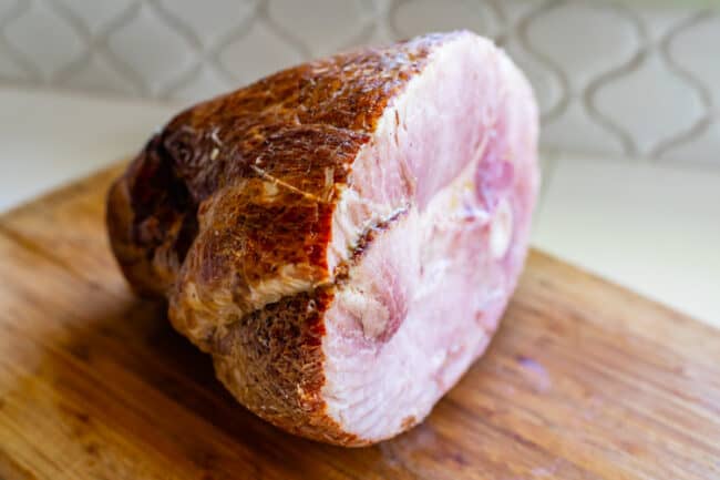 half a spiral ham on a cutting board.