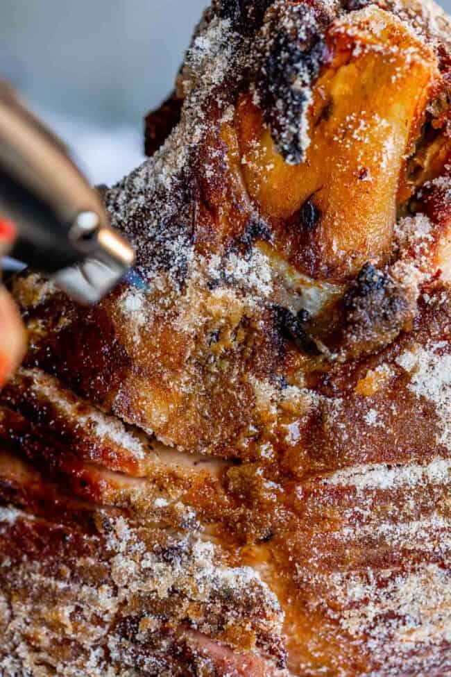 cooking a honey baked ham with a kitchen torch.