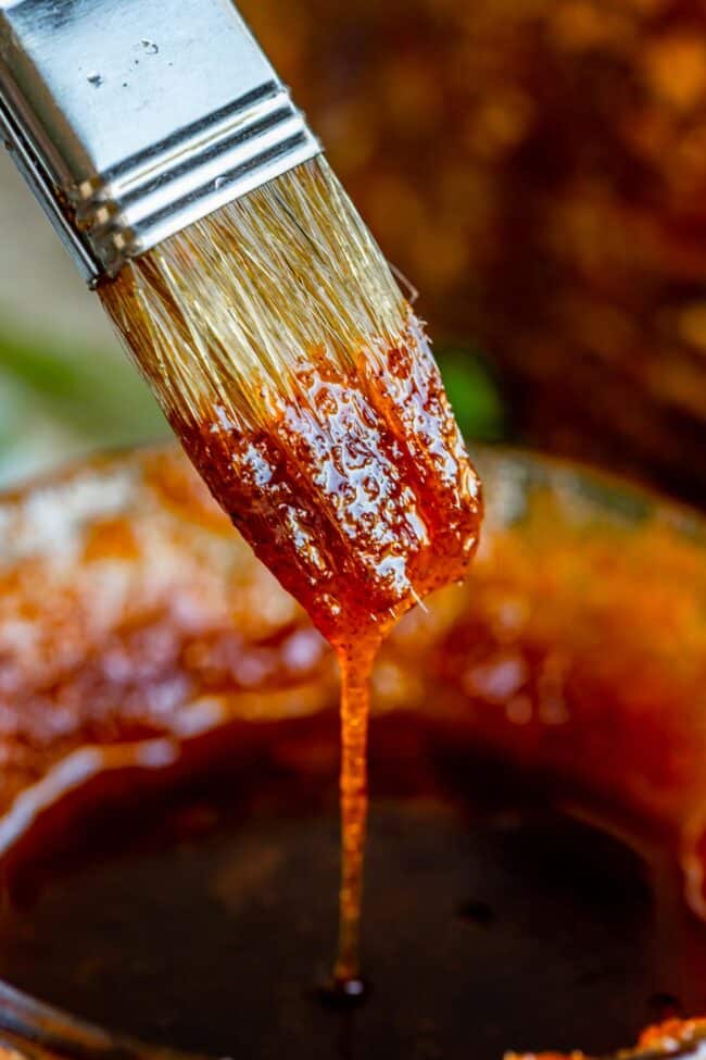 honey baked ham glaze dripping from a pastry brush.