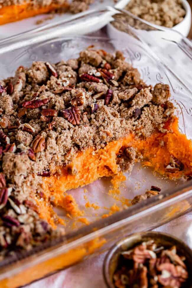 pan of sweet potato casserole with some servings missing.
