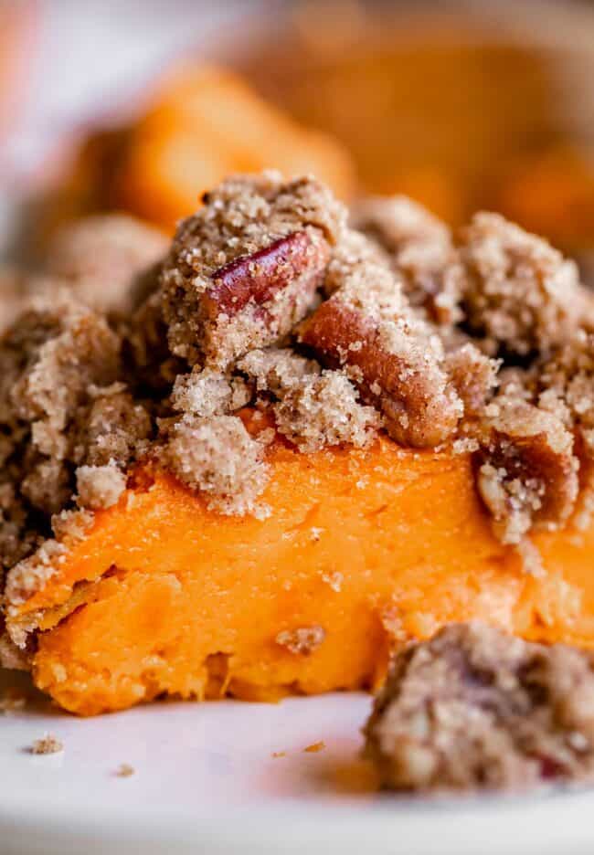 baked sweet potato casserole on a plate shot from the side.