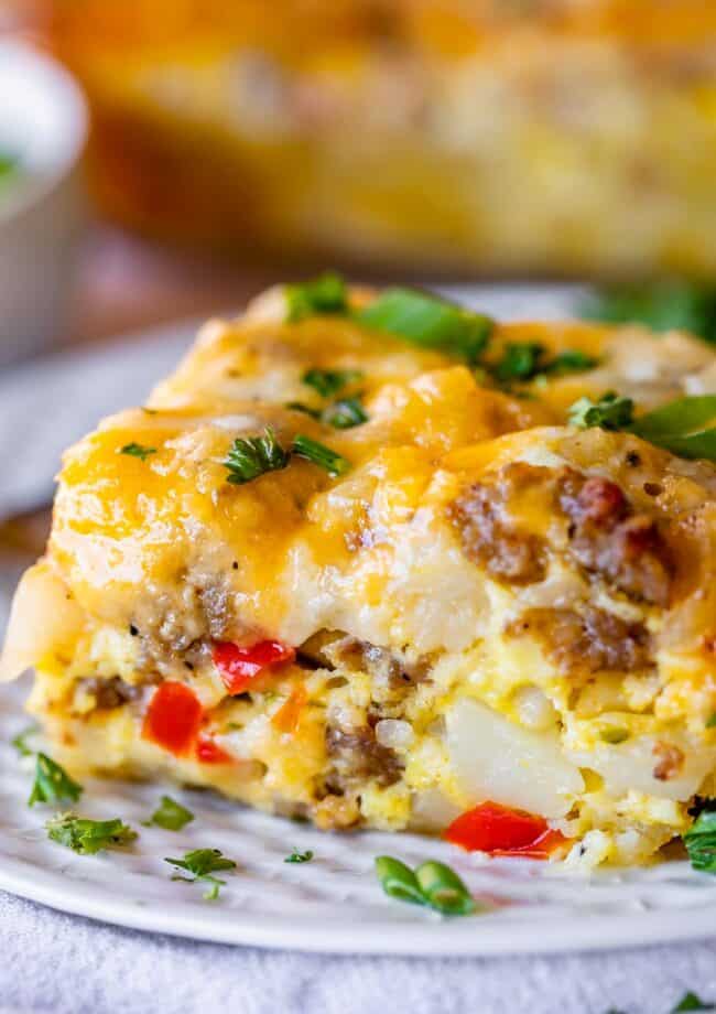breakfast sausage casserole with peppers and onions on a plate sprinkled with parsley.