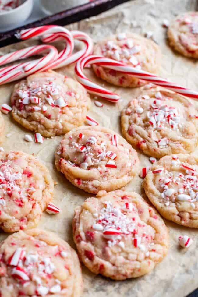 peppermint cookies on a parchment covered pan with candy canes.