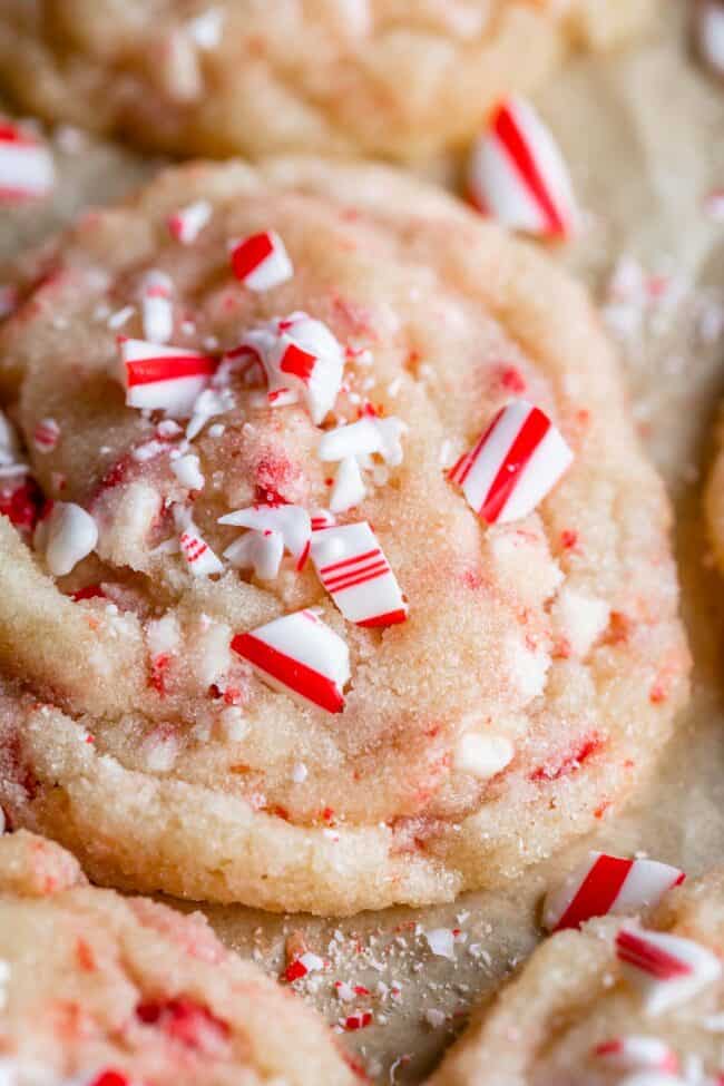 peppermint sugar cookies on a pan with crushed candy canes on top.