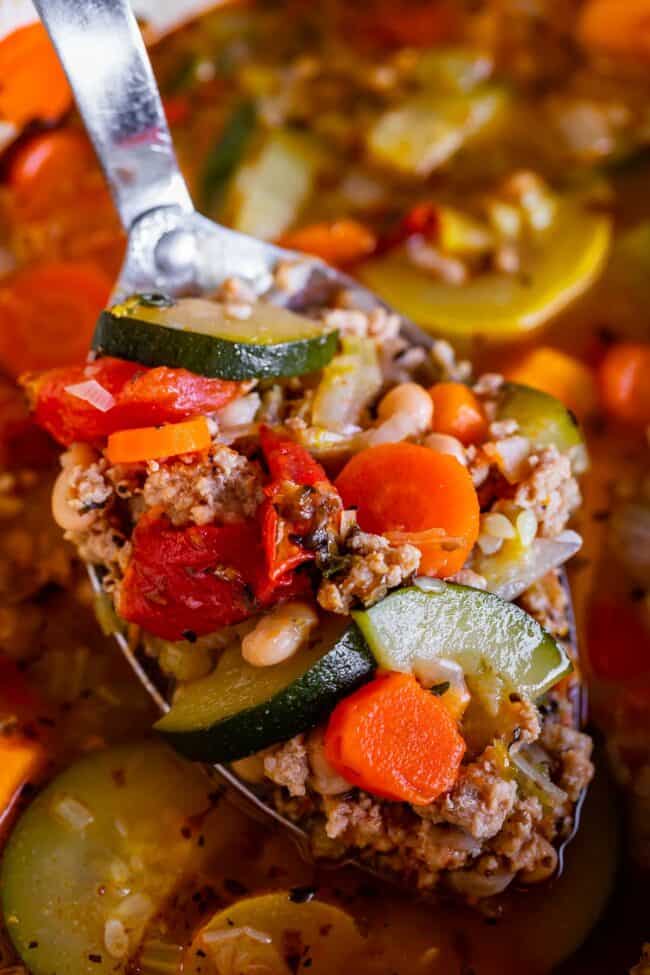 homemade turkey vegetable soup (weight loss soup) being lifted from the pot on a spoon.