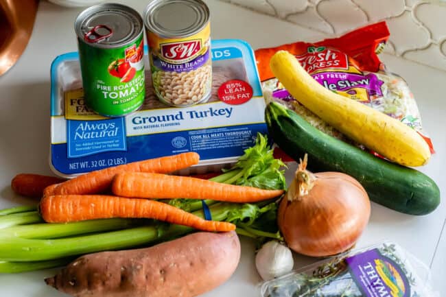 ingredients for weight loss soup including vegetables, ground turkey, and white beans.