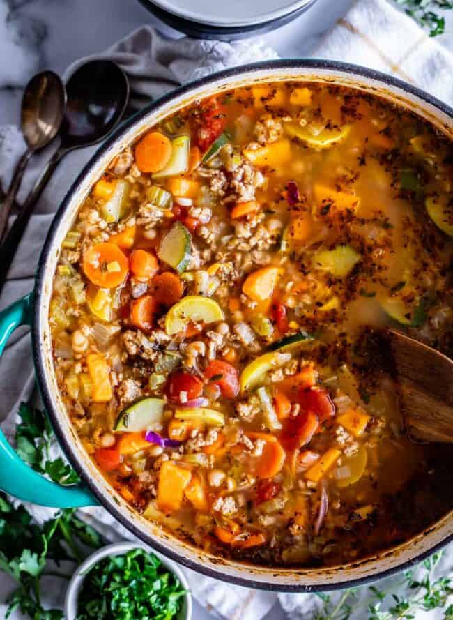 weight loss soup in a pot with a wooden spoon shot from overhead.