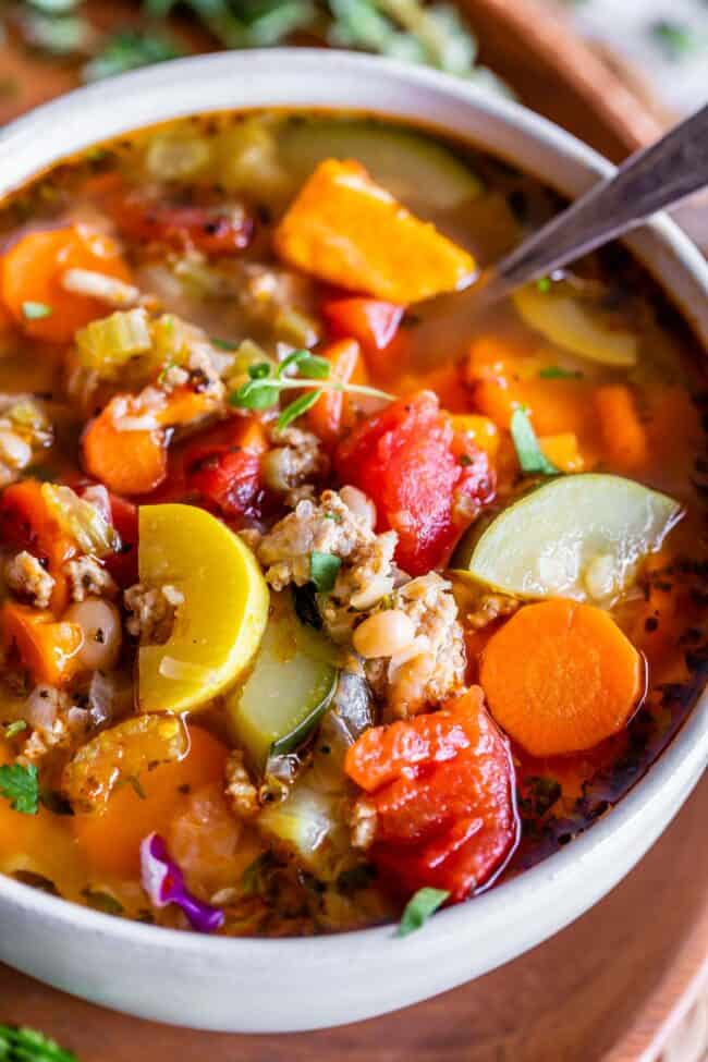 weight loss soup in a white bowl with a spoon.