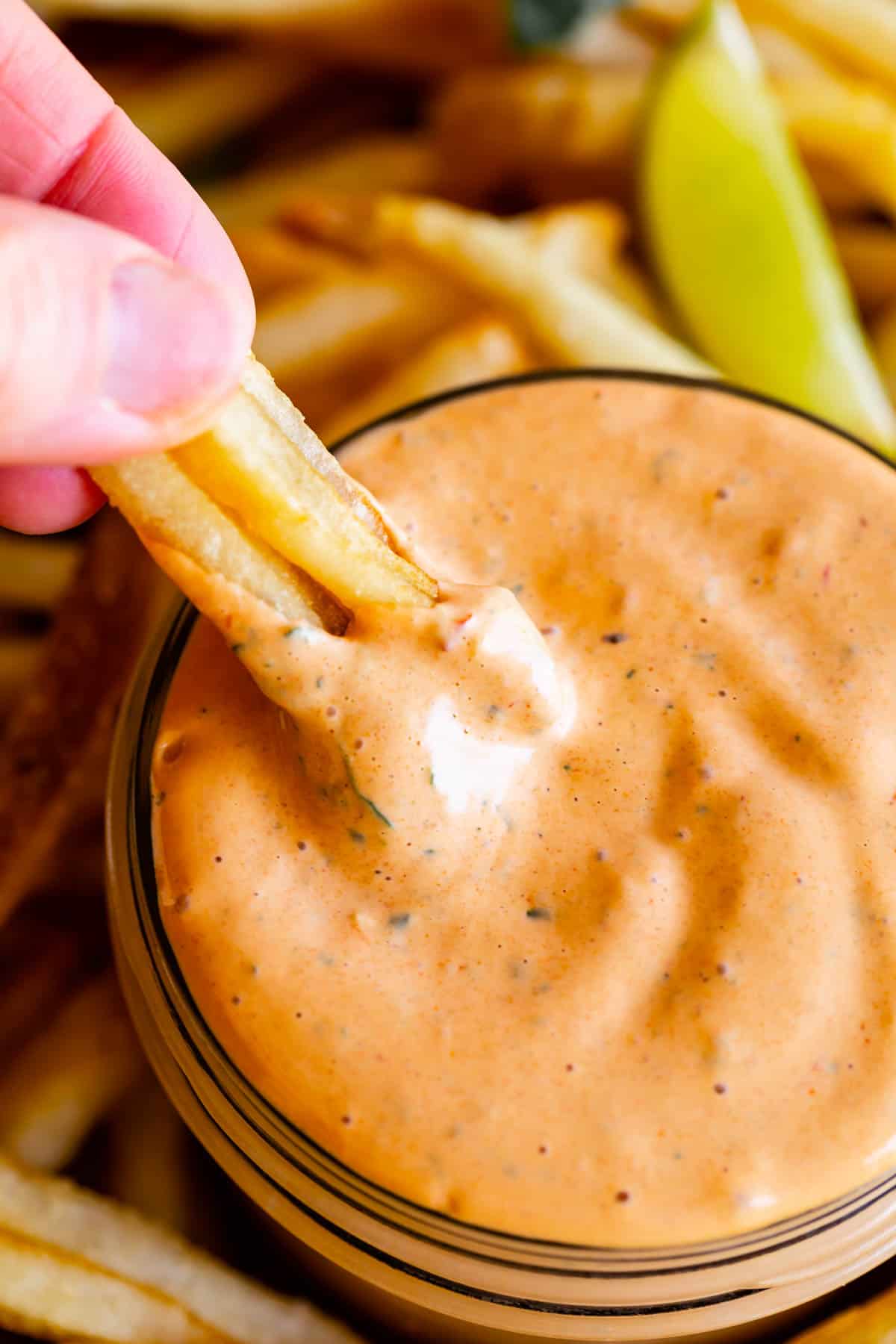 dipping french fries into chipotle mayo sauce