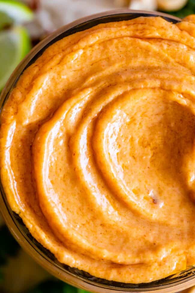 Thai peanut sauce recipe in a jar with swirls on top.