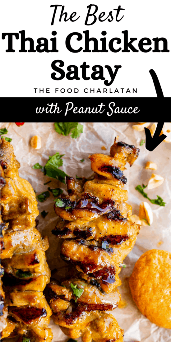 thai chicken satay skewer on parchment paper with peanut sauce