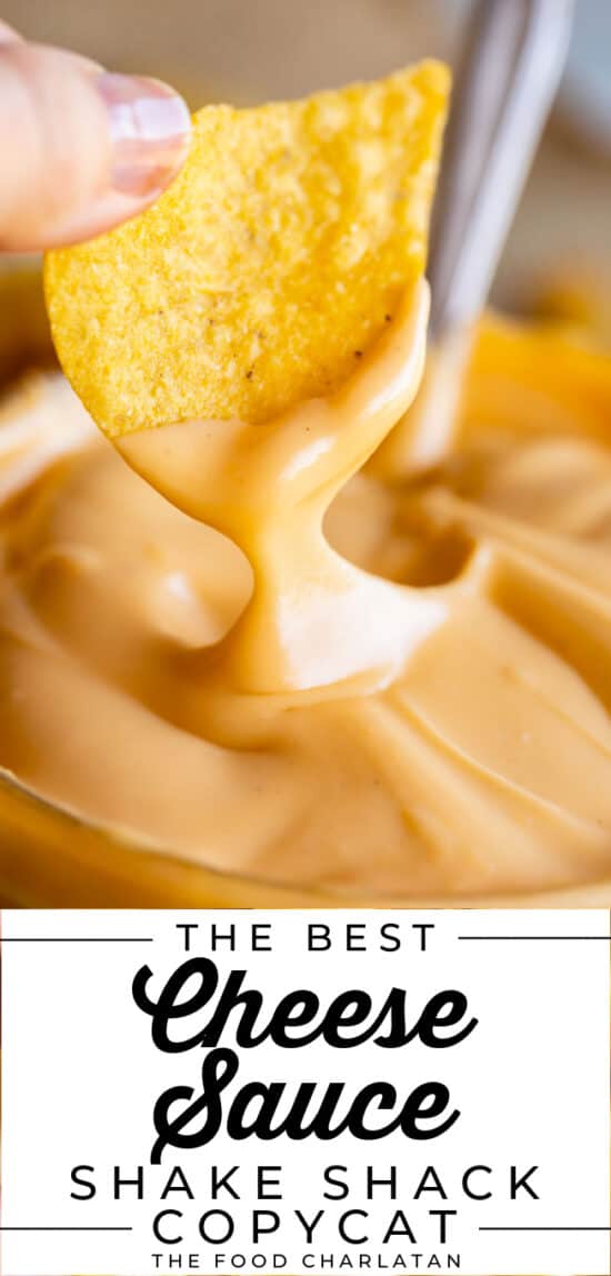 a hand dipping a tortilla chip into shack shack cheese sauce