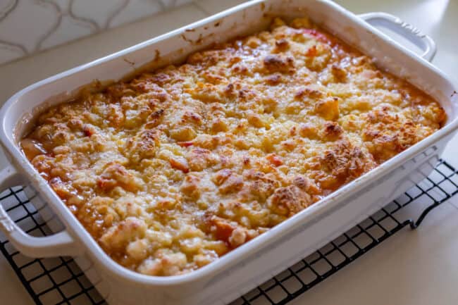 baked peach cobbler right out of the oven on a cooling rack.