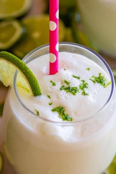 brazilian lemonade in a glass with a pink straw