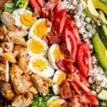 best cobb salad, with ingredients lined up across a wooden plate