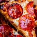 slice of homemade pizza being lifted from pan
