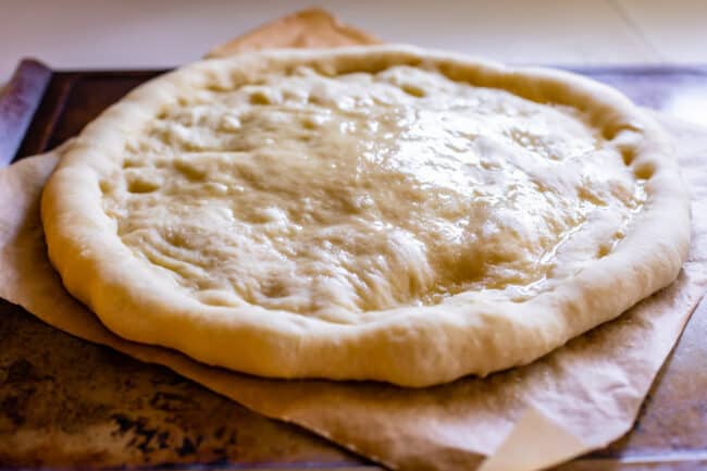 par baked pizza dough with oil rubbed on top