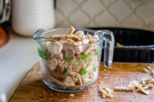 rotisserie chicken shredded in a glass measuring cup.
