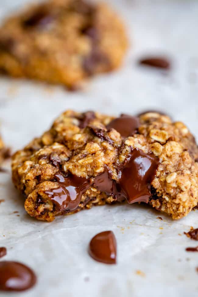healthy cookie recipes on parchment paper with a bite taken out.